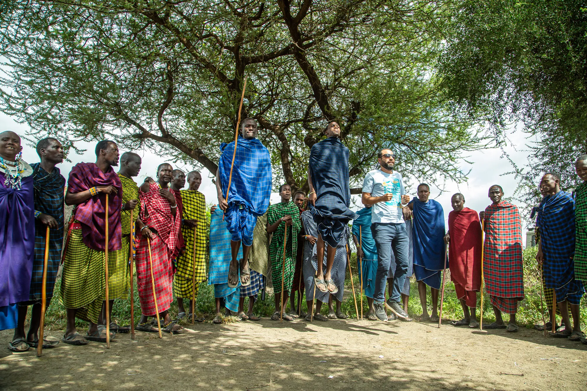African Queen Adventures guests joining Maasai men in the jumping dance