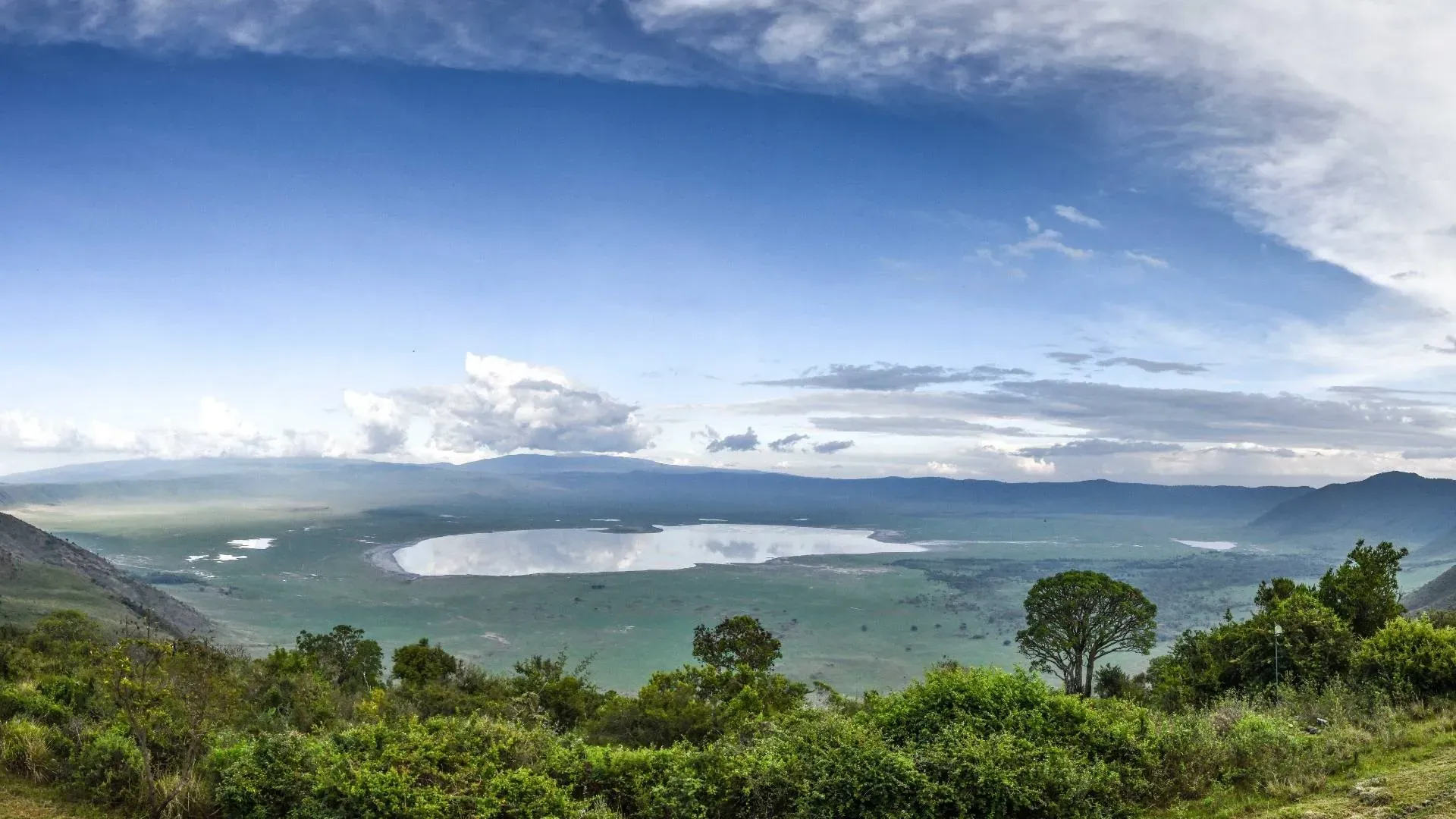 View into the Ngorongoro Crater and its lake from the forested rim