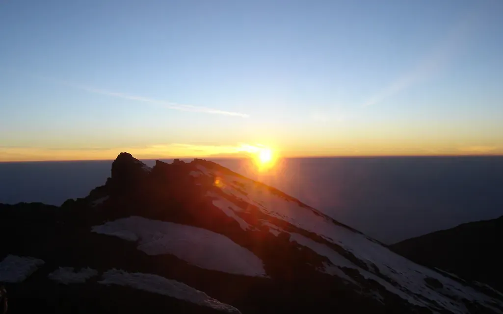 Sunrise over a rocky peak high on Kilimanjaro